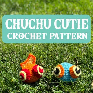 May include: Two crocheted plushies, one orange and one blue, with large eyes. The plushies are on a bed of green grass. The text "CHUCHU CUTIE CROCHET PATTERN" is displayed in a blue rectangle.