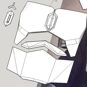 Może przedstawiać: Czarno-biały rysunek geometrycznego kształtu, prawdopodobnie hełmu lub elementu zbroi, z wieloma sekcjami, kt&oacute;re można złożyć.