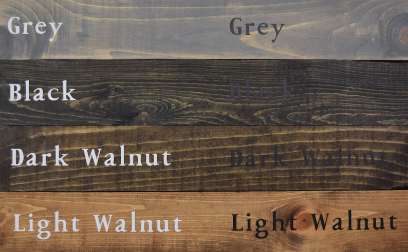 May include: Four wood samples stained in different colors: grey, black, dark walnut, and light walnut.