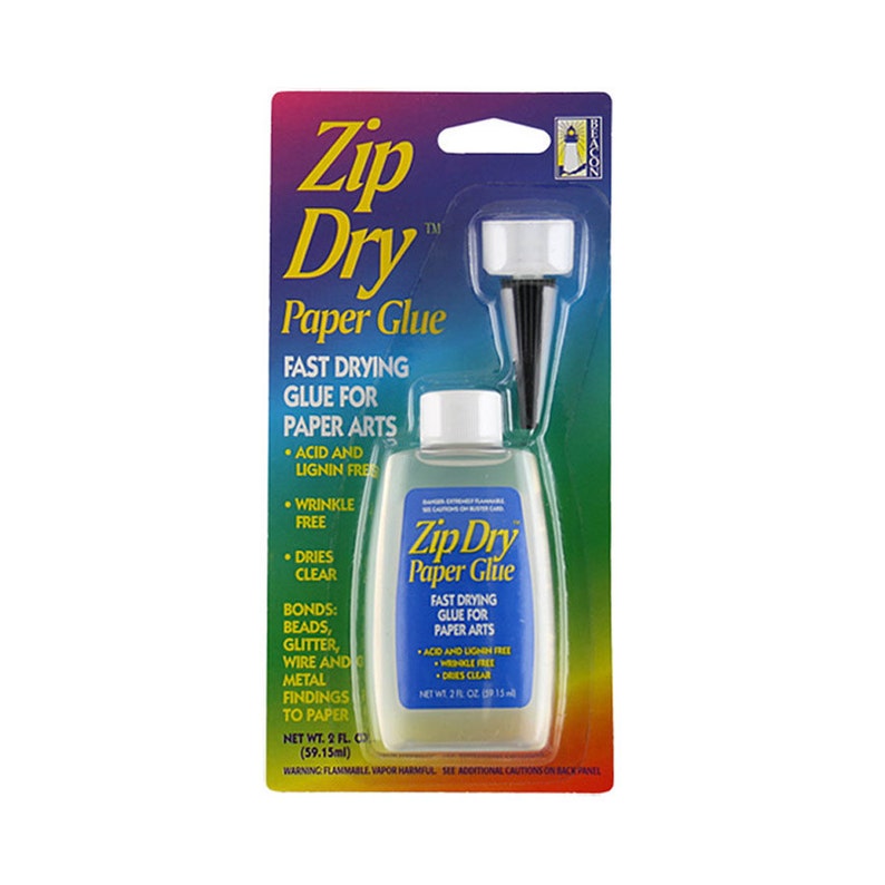 May include: A clear plastic bottle of Zip Dry Paper Glue with a black applicator tip. The bottle is labeled with the product name, "Zip Dry Paper Glue", and lists features such as "Fast Drying Glue for Paper Arts", "Acid and Lignin Free", "Wrinkle Free", and "Dries Clear". The bottle is 2 fl oz (59.15 ml).