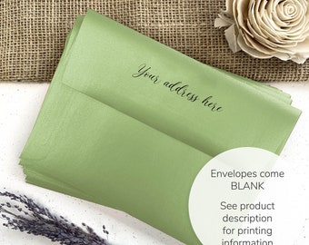 May include: A stack of light green envelopes with the text "Your address here" in elegant script. The envelopes are blank and ready for customization. A sprig of lavender and a decorative flower are also visible.