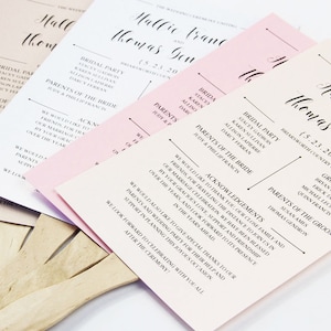 May include: A set of three pink and white wedding ceremony fans with black calligraphy text. The text includes the names Mallic and Thomas, the date 5.23.2021, and the words "Bridal Party", "Parents of the Bride", and "Acknowledgements".