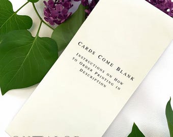 May include: A rectangular off-white card featuring black text that reads: CARDS COME BLANK. INSTRUCTIONS ON HOW TO ORDER PRINTING IN DESCRIPTION. The brand name ONMALOP is printed at the bottom. The card is surrounded by purple lilac flowers.