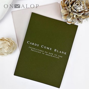 May include: A dark olive green card with the white text CARDS COME BLANK and INSTRUCTIONS ON HOW TO ADD PRINTING IN DESCRIPTION, placed over a light pink envelope, accompanied by two decorative wooden flowers with silver-painted edges.