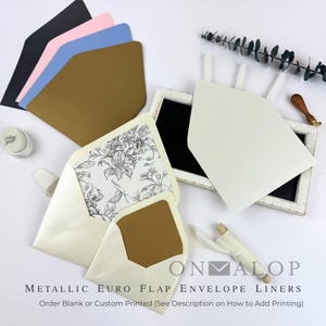May include: A collection of metallic Euro flap envelopes in black, pink, blue, gold, and cream, with one cream envelope featuring a black and white floral liner. The text ONMALOP is visible, along with the phrase METALLIC EURO FLAP ENVELOPE LINERS.