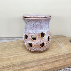 May include: A set of three ceramic nesting bowls in graduating sizes. The bowls feature a speckled, cream-colored exterior and a contrasting dark brown interior. The largest bowl is approximately 8 inches in diameter.
