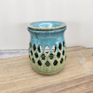 May include: A set of three ceramic mugs with a speckled, matte finish. The mugs are in shades of cream, light gray, and dark gray. Each mug has a simple, minimalist design, perfect for coffee or tea.