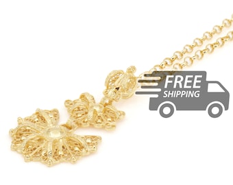 May include: A gold-toned pendant necklace featuring intricate filigree metalwork. The pendant consists of a circular, fan-like base connected to a smaller, crown-shaped top piece, all suspended from a matching gold-toned link chain.