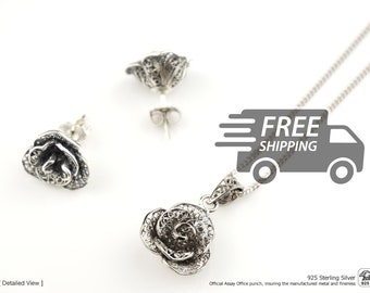 May include: A 925 sterling silver jewelry set featuring a rose-shaped pendant on a delicate chain and two matching rose-shaped stud earrings. Each piece displays intricate filigree metalwork with a dark oxidized finish for contrast.