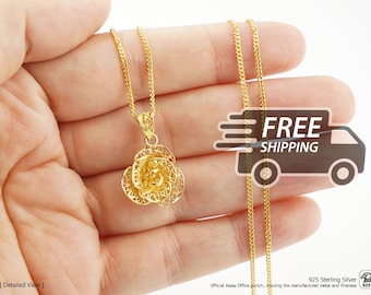 May include: A gold-colored necklace featuring a delicate filigree rose pendant suspended from a fine curb chain. The intricate metalwork creates a lace-like floral pattern. The piece is marked with 925 Sterling Silver and an assay office punch.