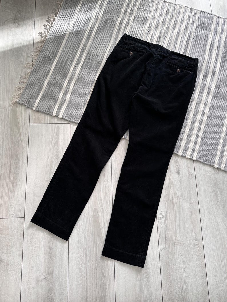 Puede incluir: Pantal&oacute;n de pana negro de pierna recta.