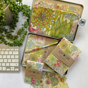 May include: A set of three floral patterned notebooks and a matching pencil case. The notebooks are titled "Kitty Jane" and are labelled "Mini Notes" and "A5 Notebook".