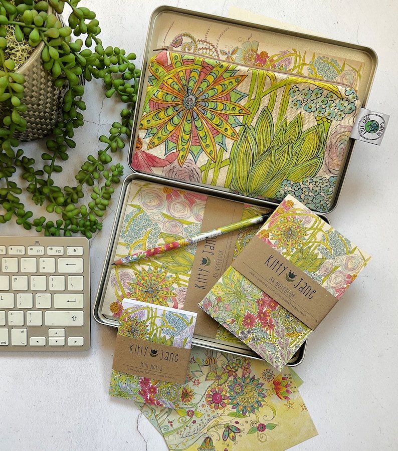 May include: A set of three floral patterned notebooks and a matching pencil case. The notebooks are titled "Kitty Jane" and are labelled "Mini Notes" and "A5 Notebook".