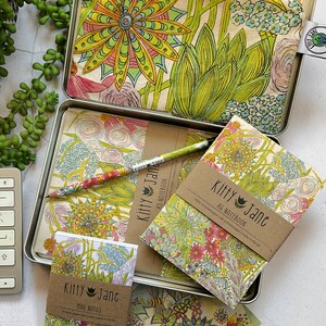 May include: A set of three floral patterned notebooks and a pencil pouch. The notebooks are titled "Kitty Jane A6 Notebook" and "Kitty Jane Mini Notes". The pouch is titled "Kitty Jane".