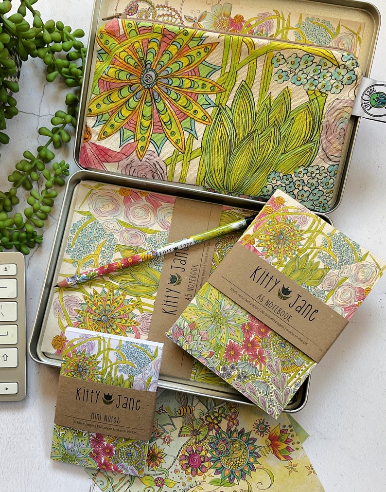 May include: A set of three floral patterned notebooks and a pencil pouch. The notebooks are titled "Kitty Jane A6 Notebook" and "Kitty Jane Mini Notes". The pouch is titled "Kitty Jane".