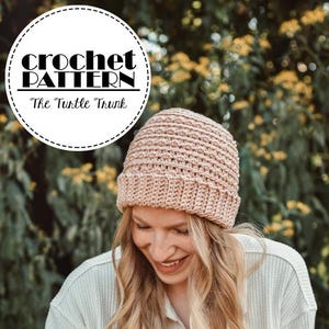 May include: A light brown crochet beanie with a ribbed brim. The image also features the text "Crochet Pattern" and "The Turtle Trunk" in a circular design. The beanie is worn by a person with long blonde hair, wearing a light green shirt and a light-colored button-down shirt.