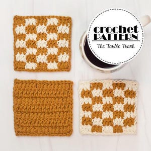 May include: Four crocheted coasters in a checkered pattern. Two coasters are white and brown, and two are solid brown. The coasters are arranged in a square on a white surface. The text "crochet pattern" is written in black on a white circle with a black border.