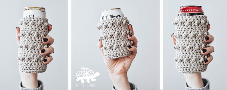 May include: Three crocheted can cozies in a beige color with a textured design. The cozies are on aluminum cans.