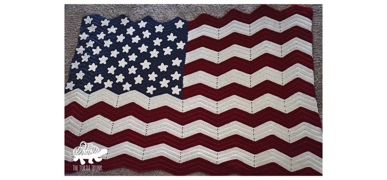 May include: A crocheted American flag blanket in red, white, and blue. The stars are white on a blue background, and the stripes are red and white.
