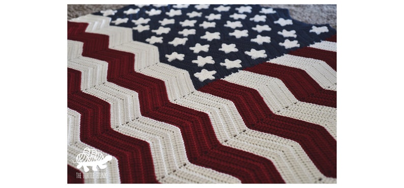 May include: A crocheted American flag blanket with red, white, and blue stripes and stars. The blanket is made with a chevron stitch pattern.