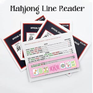 May include: A stack of Mahjong Line Reader cards with the text "Mahjong Line Reader" at the top. The cards have a pink and white color scheme with printed rules and values. The cards are labeled "Official Sta" and "2025".