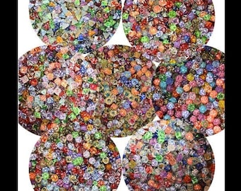 May include: An assortment of colorful polyhedral dice, each with multiple sides, arranged in circular patterns. The dice are a mix of colors, including red, blue, green, and yellow. Text at the top reads: "Do NOT expect perfection from Factory Mass Produced dice in this price range."