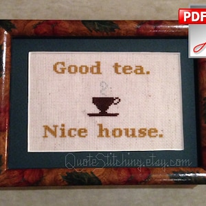 May include: A framed cross-stitch with the text "Good tea. Nice house." and a small image of a teacup with steam coming from it.
