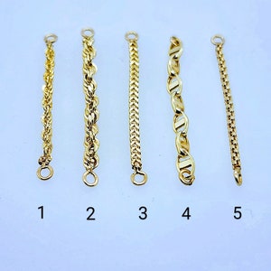 May include: Five gold chains with different link styles. The chains are numbered 1 through 5.