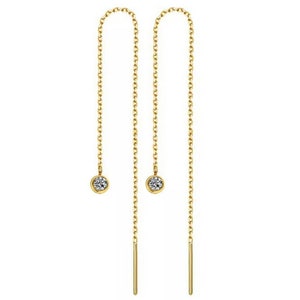May include: A pair of gold-toned chain earrings with a small clear crystal at the end of each chain.