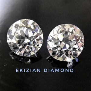 May include: Two clear round diamonds on a black background. The text "EKIZIAN DIAMOND" is printed below the diamonds.