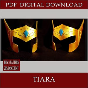 May include: Two gold-colored tiaras with a blue gem in the center. The tiaras have a decorative design and are displayed on a black background. Text at the top reads "PDF DIGITAL DOWNLOAD" and at the bottom "TIARA".