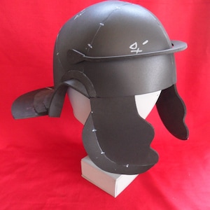 May include: A black foam helmet with a visor and a flap on the back. The helmet has white markings on it.
