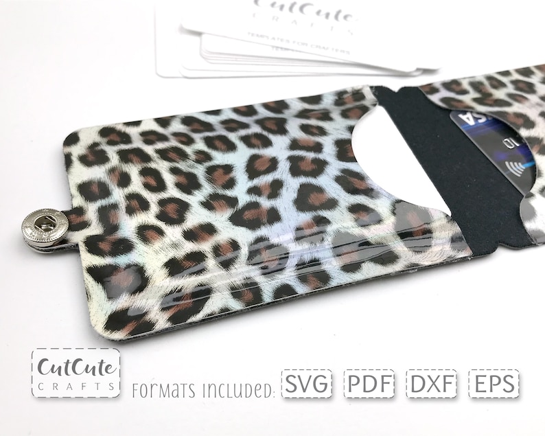 May include: A leopard print card holder with a clear plastic front and a black back. The card holder has a snap closure and is designed to hold credit cards or other small items. The image includes the text "CutCute Crafts" and "Formats Included: SVG PDF DXF EPS".