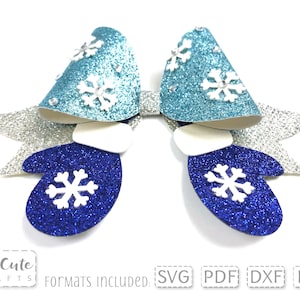 May include: A blue and teal glitter bow with white snowflake accents and silver glitter wings. The bow is shaped like mittens with white cuffs. The bow is a digital cut file for crafting.
