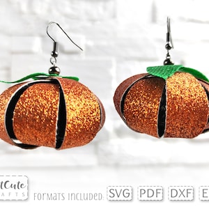 May include: A pair of orange glitter pumpkin earrings with green felt leaves. The earrings are made of felt and have a silver hook.