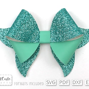 May include: A teal glitter bow with a light green centre. The bow is made of felt and has a layered design. The text "FORMATS INCLUDED: SVG PDF DXF EPS" is printed below the bow.