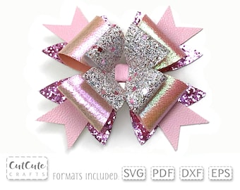 May include: A pink and silver glitter bow with a layered design. The bow is made of faux leather and has a sparkly finish. The bow is perfect for adding a touch of sparkle to any project.
