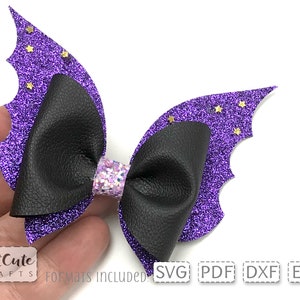 May include: Purple glitter bat wings with gold glitter stars and a black faux leather bow.  The bow has a center of iridescent glitter.  SVG, PDF, DXF, and EPS formats included.