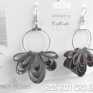 May include: A pair of silver hoop earrings with a gray and iridescent ribbon bow attached to each hoop. The earrings are displayed on a white card with the text "Handmade by CutCute Crafts" and "Formats Included: SVG DXF PDF EPS".