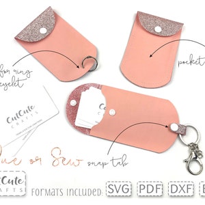 May include: Pink leatherette pocket-sized cases with glittery tops and snap closures. One case has a keyring, another has a hole for a ring or eyelet, and the third is a pocket only. The cases are designed by CutCute Crafts.