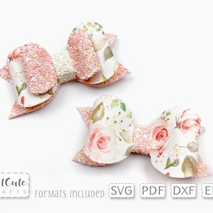 Może przedstawiać: Dwa różowe i białe kokardki do włosów z kwiatowym wzorem i błyszczącymi akcentami. Kokardki są wykonane z tkaniny i przeznaczone są do włosów dziewczynek.