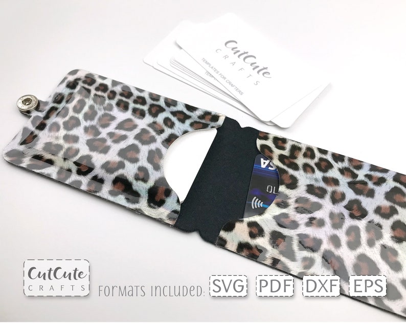 May include: A leopard print card holder with a black flap and a snap closure. The card holder is open and a credit card is visible inside. The text "CutCute CRAFTS" and "Formats INCLUDED: SVG PDF DXF EPS" is visible at the bottom of the image.