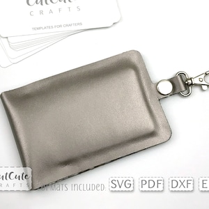 May include: A silver leather key chain with a metal clasp. The key chain is designed to hold a small card or ID. The text "CutCute Crafts" is visible in the bottom left corner of the image.