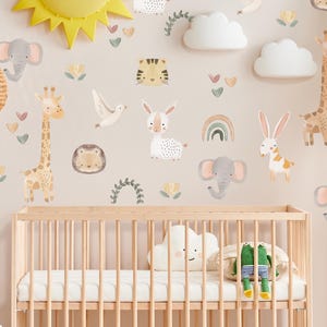 May include: A set of nursery wall decals featuring a variety of cute animals, including a giraffe, elephant, tiger, bunny, and a bird. The decals are in a watercolor style and are perfect for a baby's room.