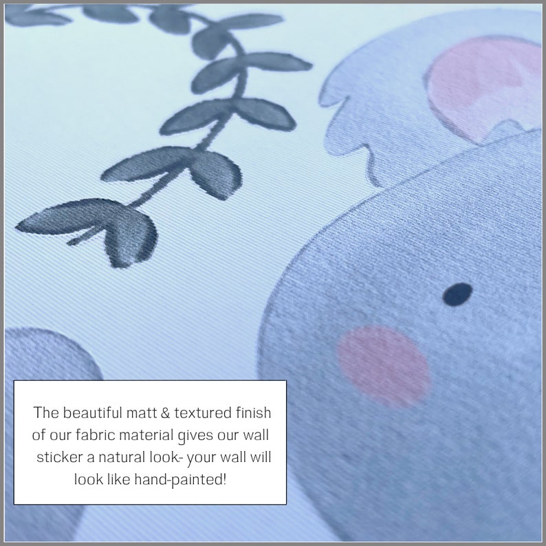 May include: Close-up of a light blue and pink fabric wall sticker with a textured finish. The sticker features a cartoon elephant with a leafy vine behind it. The text "The beautiful matt & textured finish of our fabric material gives our wall sticker a natural look- your wall will look like hand-painted!" is visible in the image.