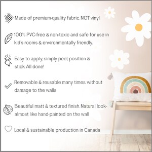 May include: A set of white daisy flower wall decals with a rainbow pillow on a bench. The decals are made of fabric and are reusable and removable. The text on the image reads: "Made of premium-quality fabric. NOT vinyl. 100% PVC-free & non-toxic and safe for use in kid's rooms & environmentally friendly. Easy to apply, simply peel, position & stick All done! Removable & reusable many times. without damage to the walls. Beautiful matt & textured finish. Natural look-almost like hand-painted on the wall. Local & sustainable production in Canada."