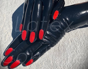 May include: Black latex gloves with long, red fingernails. The gloves are glossy and form-fitting, with a smooth surface. The image is taken in natural light, highlighting the sheen of the material. The gloves are a bold fashion statement.