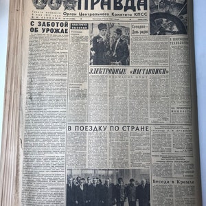 May include: A black and white newspaper with the headline "Pravda" in bold, red letters. The newspaper is from May 5, 1962, and features articles about agriculture, technology, and a visit by Soviet leader Leonid Brezhnev.