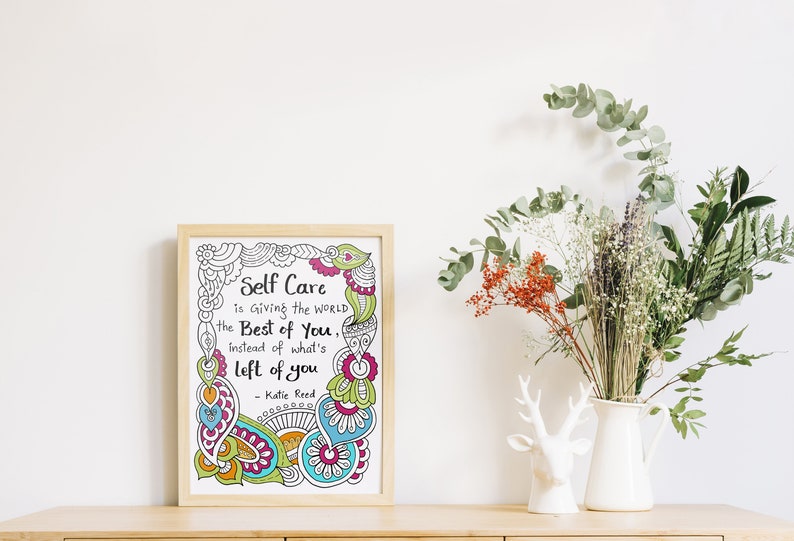 May include: A framed print with a white background and colourful doodle border. The print features a quote about self-care: "Self Care is giving the world the Best of you, instead of what's left of you." - Katie Reed
