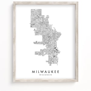 May include: A black and white typography map of Milwaukee, Wisconsin. The map is made up of the names of neighborhoods in the city. The city name is written in large letters at the bottom of the map.